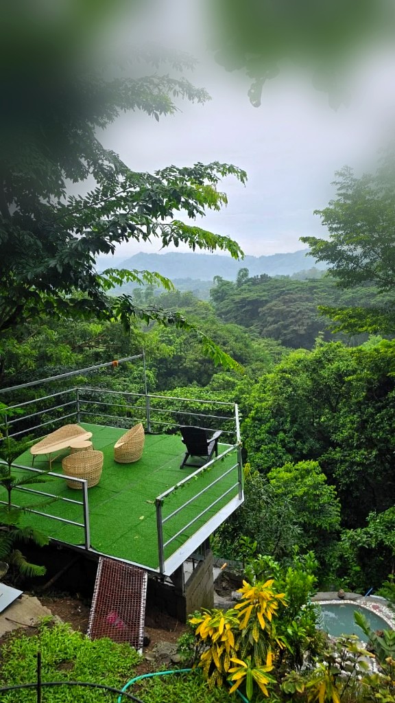 Green play lawn deck overlooking misty mountains